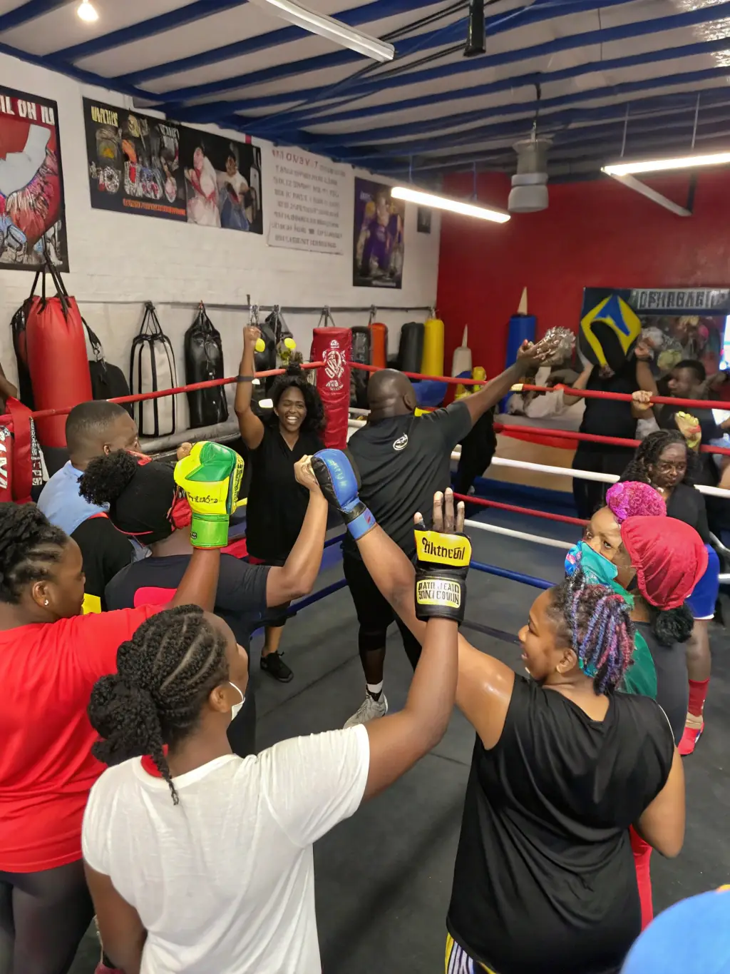 A group of arm wrestlers of different ages and genders participating in a training session, showcasing inclusivity and community spirit.